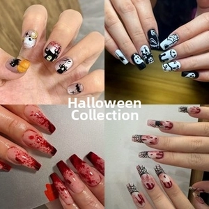 Detailed view of Halloween press-on nails featuring pumpkin, ghost, and spider web designs