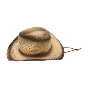 Side view detail of a woven cowboy straw hat with gradient brown and beige tones