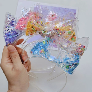 Detail of transparent PVC Christmas headbands filled with colorful sequins and fruit slices