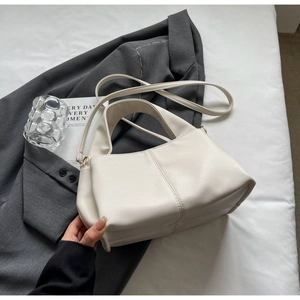 Chic off-white litchi grain shoulder bag styled on a grey blazer for office aesthetic