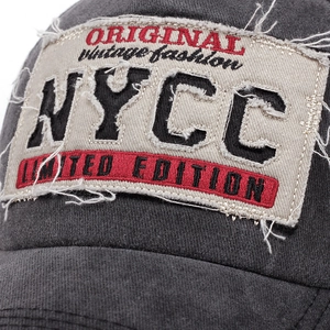 Vintage dark gray baseball cap with distressed NYCC patch embroidery and frayed edges