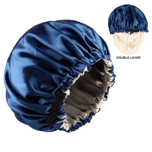 Detail of double-layer satin sleep bonnet featuring a navy outer and beige silk lining