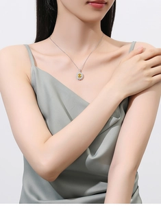 Close-up of S925 sterling silver necklace with yellow gemstone sunflower pendant on model