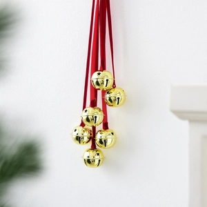 Golden Christmas bells with star cutouts and red ribbon hanger for holiday home decor