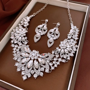 Detailed close-up of a silver vintage jewelry set with sparkling rhinestones in a gift box
