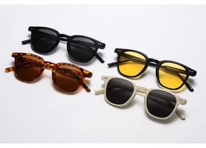Détail de lunettes de soleil rondes rétro en plusieurs coloris avec rivets en métal