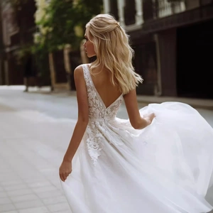 Elegant white French lace bridal gown with deep V-back and flowing layered tulle train