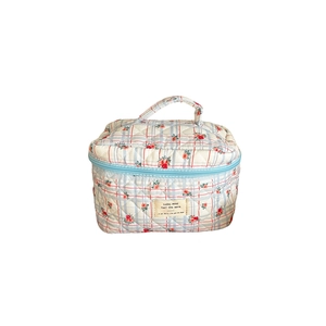 Quilted floral makeup bag with blue checkered pattern and handle for travel organization
