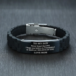 Detail of black silicone bracelet with engraved stainless steel plate for my son