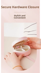 Portable travel round jewelry box with mirror, ring slots, and necklace hooks for women.