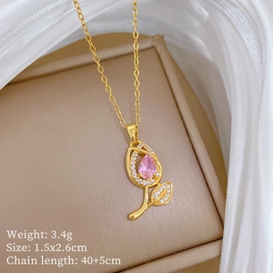 Detail view of flower pendant necklace with pink gemstone on elegant beige jewelry box