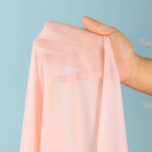 Detail shot of the pink breathable mesh fabric showing translucency and fine texture
