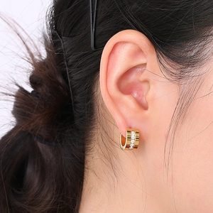 Close-up of gold stainless steel hoop earring with sparkling cubic zirconia inlay