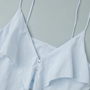 Detail view of cotton light blue camisole top with ruffle trim, buttons and V-neckline