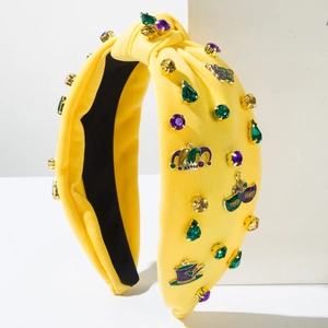 Detail of yellow Mardi Gras headband with colorful gemstones and carnival themed badges