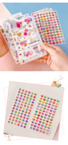 Close-up of translucent colorful heart and star washi stickers on a white journal page
