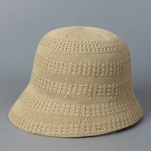 Detailed close-up of breathable hollow-out knitting texture on a beige bucket hat