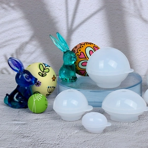 Detailed view of spherical silicone resin molds with finished egg-shaped craft samples
