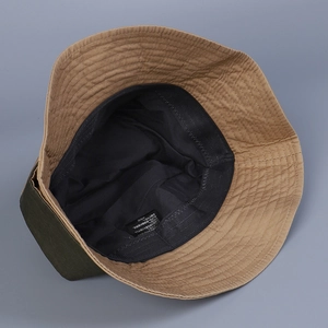 Detail of army green cotton bucket hat showing inner black lining and stitching quality