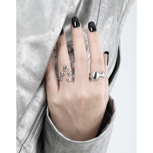 Minimalist S925 sterling silver irregular open rings on model with modern silver jacket