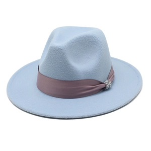 Detailed close-up of light blue wool fedora hat featuring a pink satin ribbon and rhinestone buckle