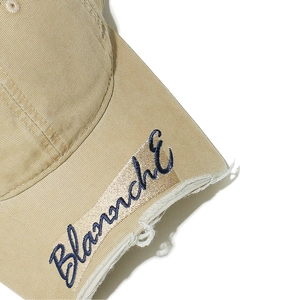 Macro detail of Blanché embroidery and distressed brim on a vintage cotton baseball cap