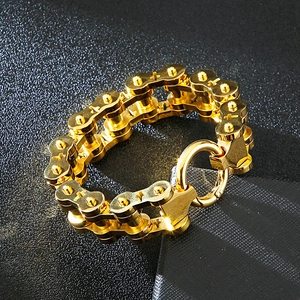 Macro view of golden cross bicycle chain bracelet with polished metallic finish
