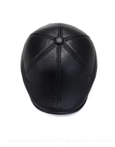 Top view of premium black faux leather flat cap showing detailed six-panel stitching and button