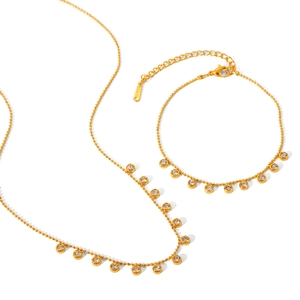 Elegant gold stainless steel jewelry set featuring tassel necklace and crystal bracelet