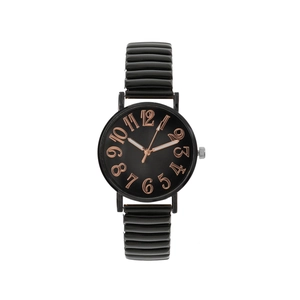 Close-up of a black watch with rose gold numerals and flexible spring strap