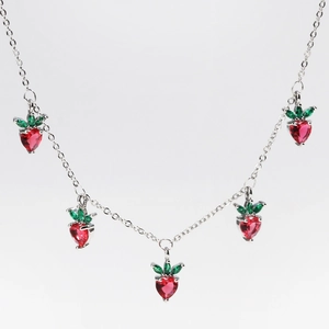 Close-up of five red strawberry pendants with colorful zircons on a silver chain