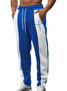 Detail view of men's blue and white joggers featuring drawstring waist and Jesus text print