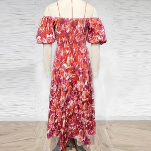 Detail of red floral print off-shoulder maxi dress with puff sleeves and layered tiers