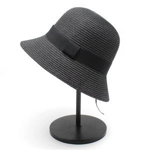 Women's black woven straw bucket hat with ribbon trim for summer sun protection