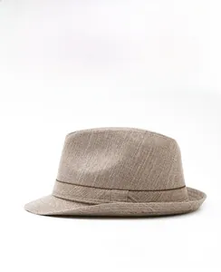 Side view detail of a light brown woven fedora hat with a decorative dark brown band