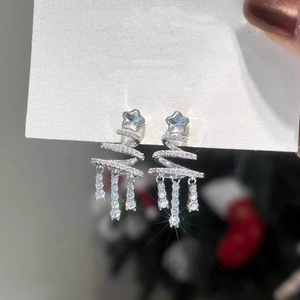 Detailed view of silver star Christmas tree earrings with rhinestone fringe and studs