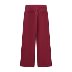 Detail view of burgundy wide-leg trousers showing back pockets and tailored waist design