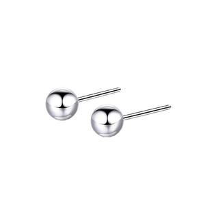 Macro shot of minimalist silver stainless steel ball stud earrings with a high-polished finish