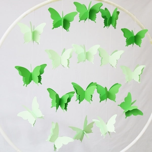 3D gradient paper butterfly garlands hanging from a white ring for party decoration