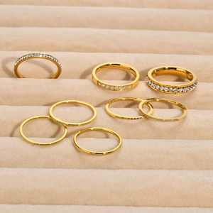 Set of gold stainless steel rings with colorful zircon inlays on a velvet tray