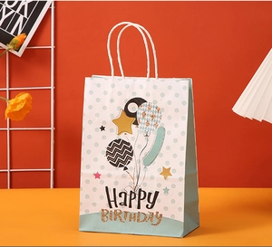 Detail of light blue polka dot Happy Birthday paper gift bag with white rope handles