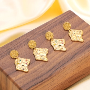 Lava texture stainless steel earrings with colorful crystals on a wooden display