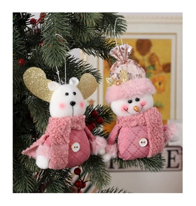 Detail of pink plaid Christmas plush ornaments hanging on tree with gold sequin ears
