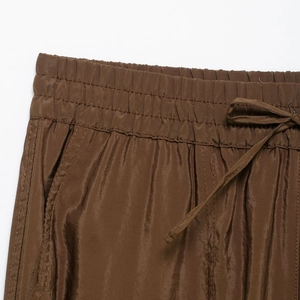 Deep brown loose-fit cargo pants with adjustable drawstring and elastic waistband detail