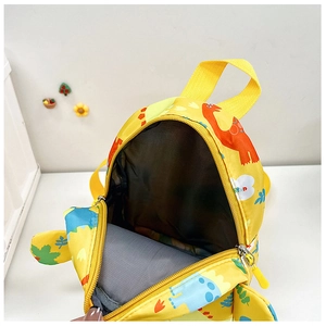 Close-up of a yellow cartoon dinosaur kid's backpack showing the interior lining space