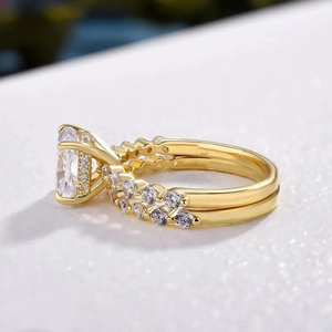 Macro shot of gold square halo engagement ring and pavé wedding band set for couples