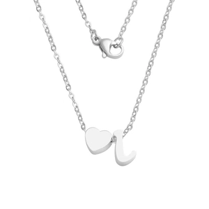 Close-up of heart charm and cursive letter J pendant on silver stainless steel chain