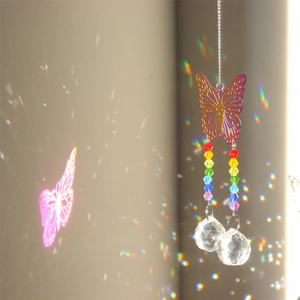 Detailed view of metal butterfly crystal suncatcher casting rainbow light on the wall