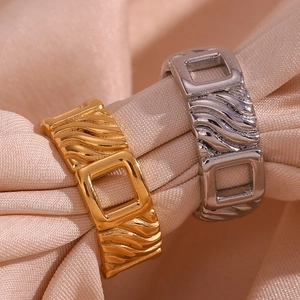 Gold and silver stainless steel rings with textured diagonal stripes and square buckle design