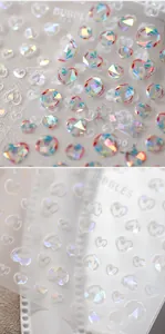 Macro shot of 3D holographic heart and bubble nail art stickers with aurora effect